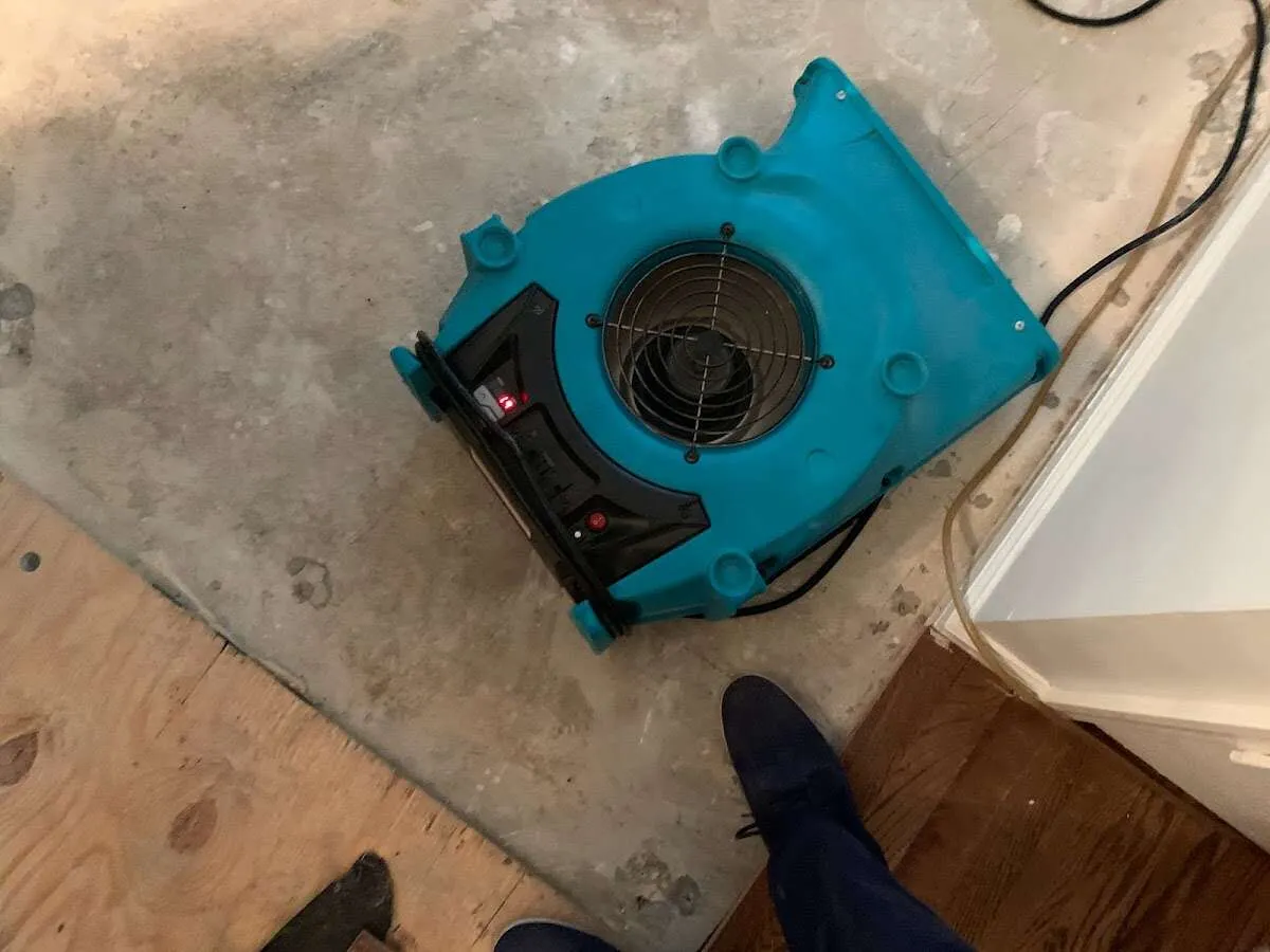 Air mover drying subfloor during Commercial Water Damage Restoration in Northfield